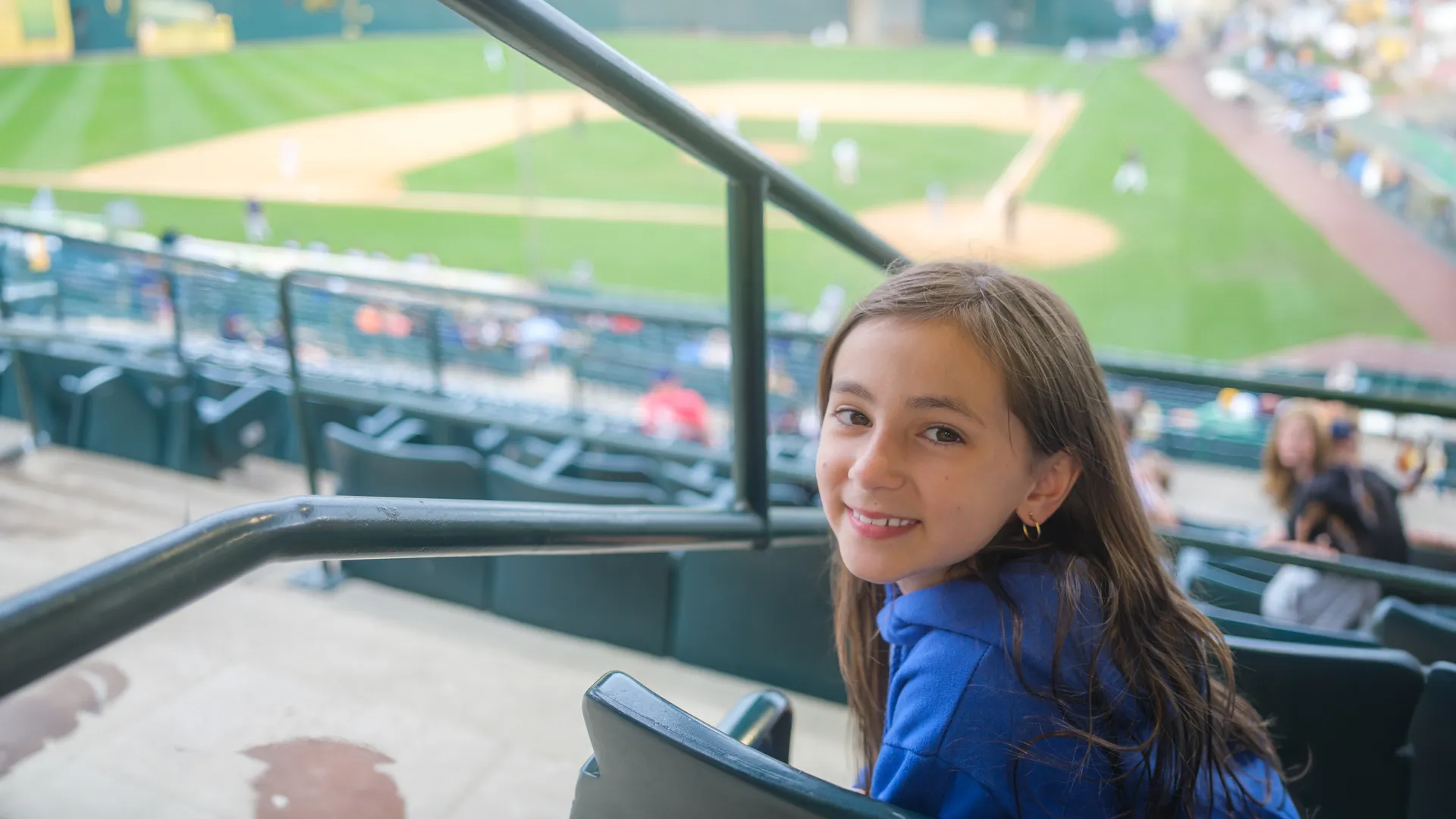 Young baseball fan sitting in a stadium during a game