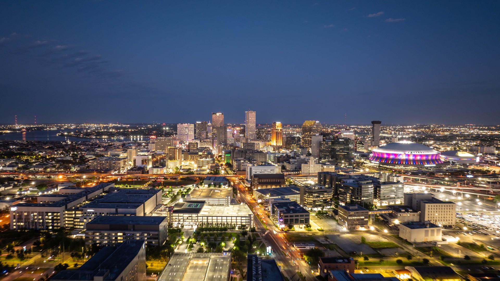 New Orleans city skyline at dusk with the Superdome visible for sports travel planning