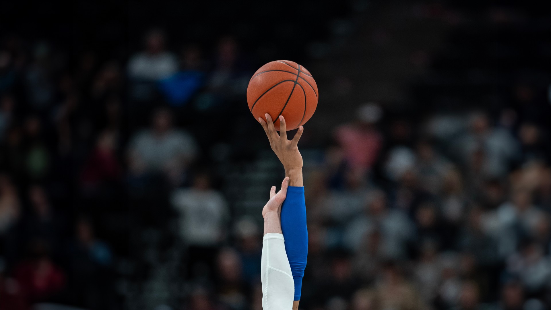 Basketball opening tipoff in an arena for Sweet 16 and Elite Eight travel
