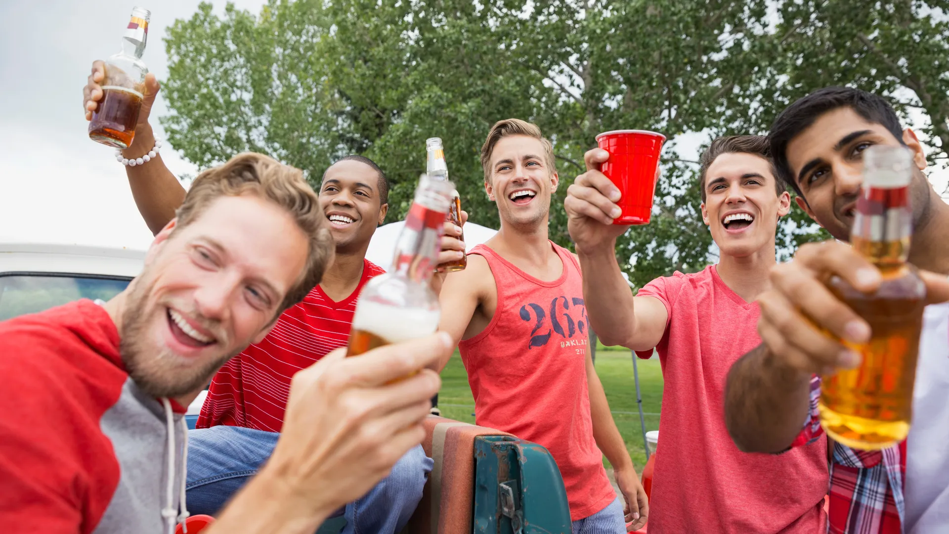 Friends cheering together during an outdoor sports trip