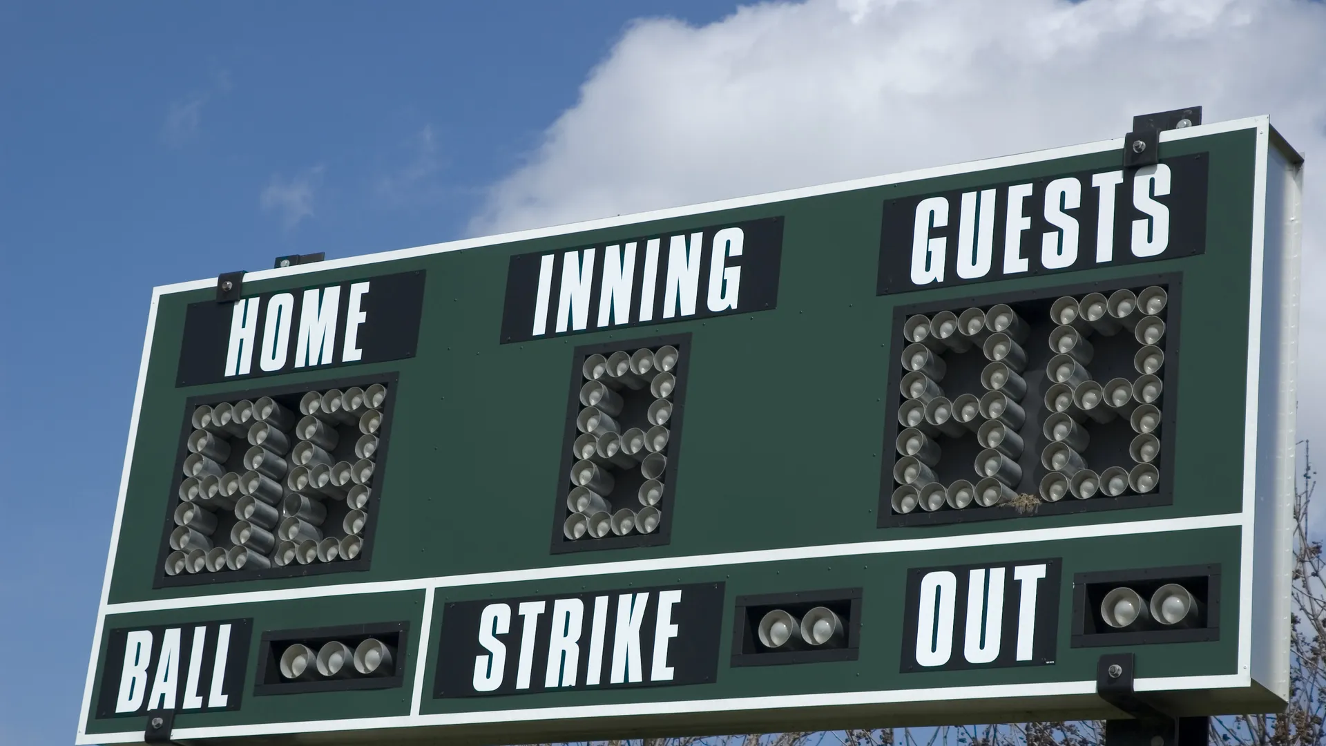 Classic baseball scoreboard above a spring ballpark field
