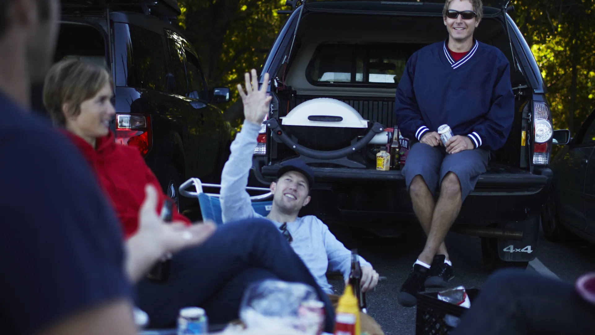 Friends enjoying a football tailgate for college football opening weekend