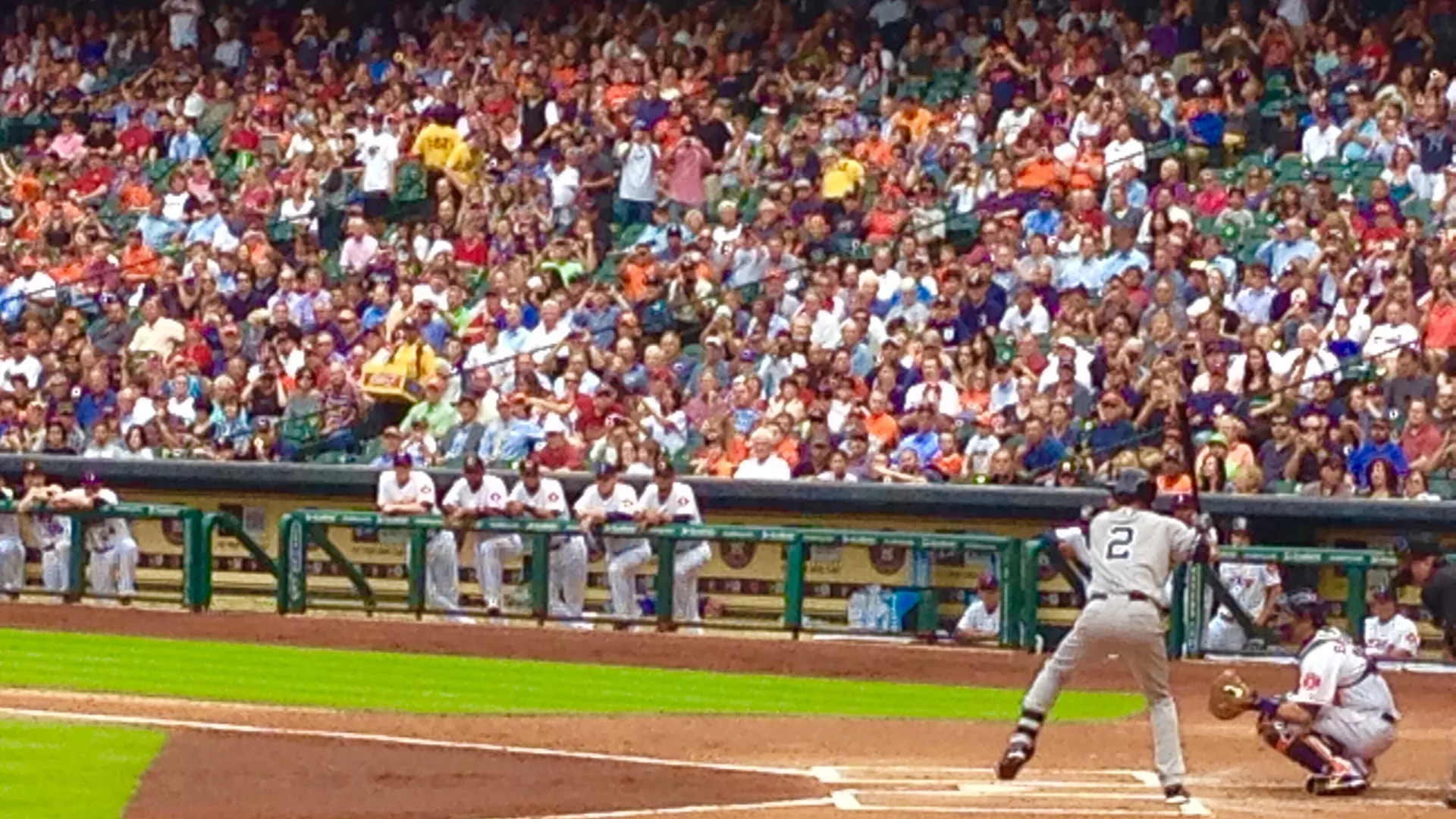 Baseball game with batter and crowd at a sunny ballpark