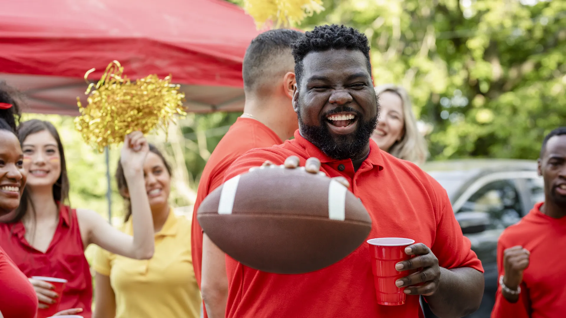 Football fans enjoying an outdoor fall tailgate party