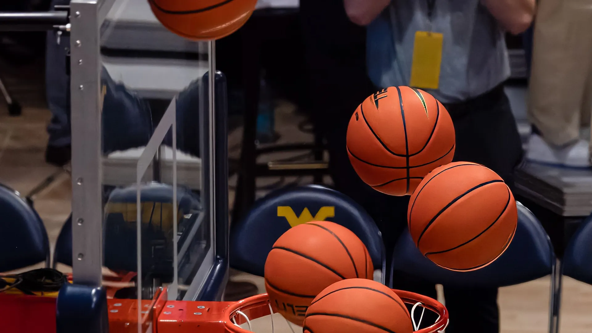 Basketballs bouncing inside an indoor tournament venue