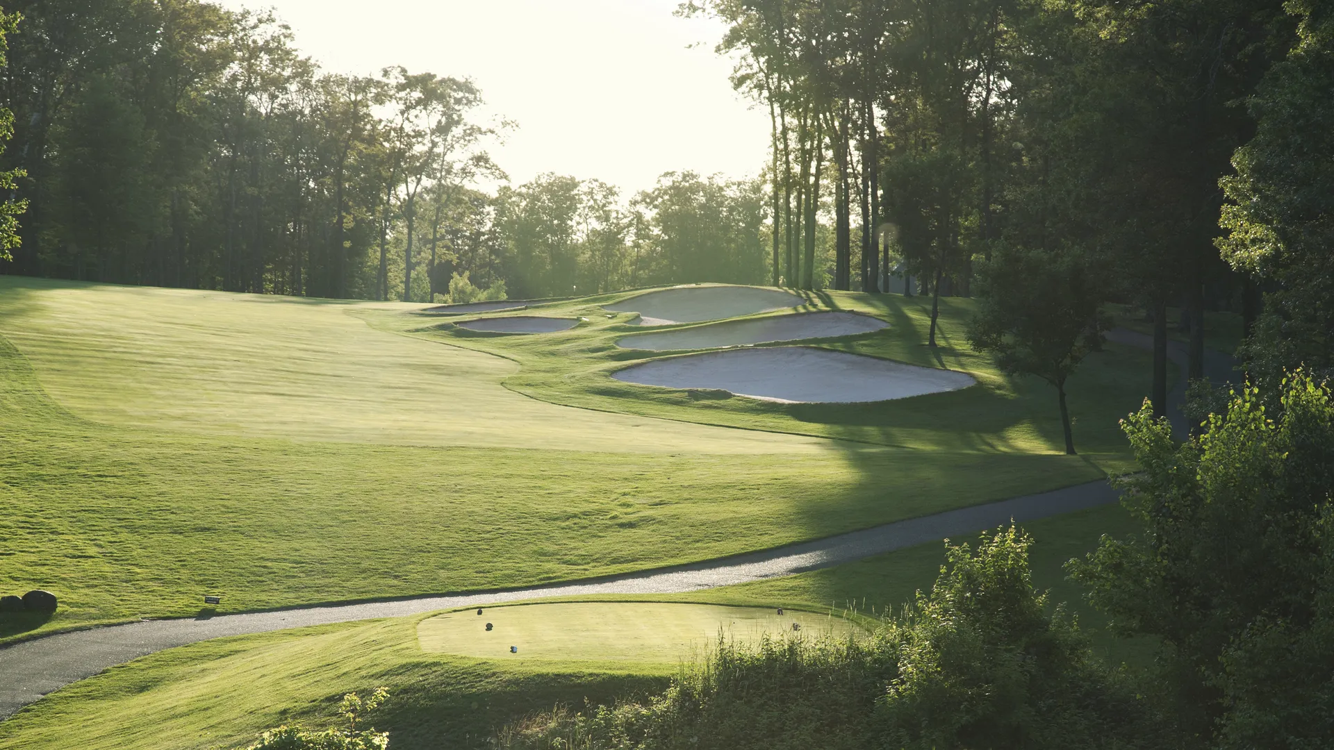 Green golf course fairway and sand traps for a Masters Tournament travel guide to Augusta