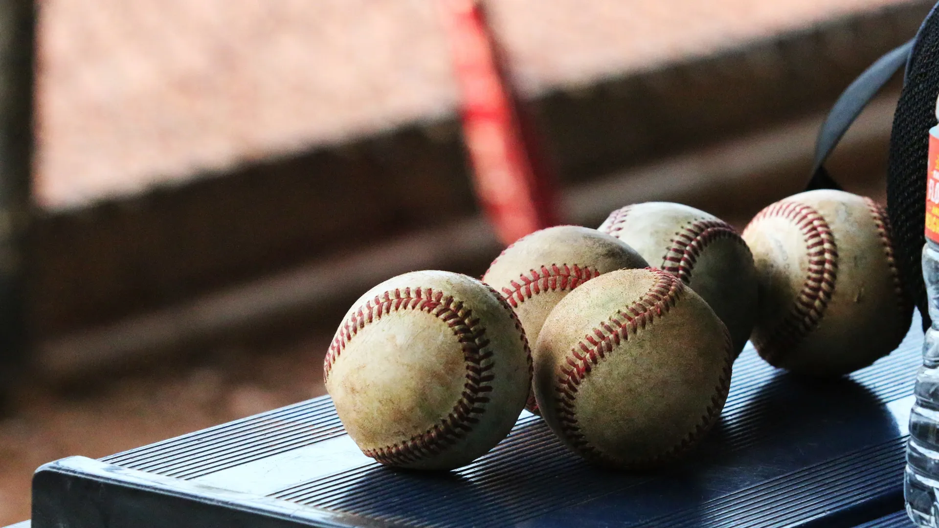 Baseballs resting on a bench during a game break
