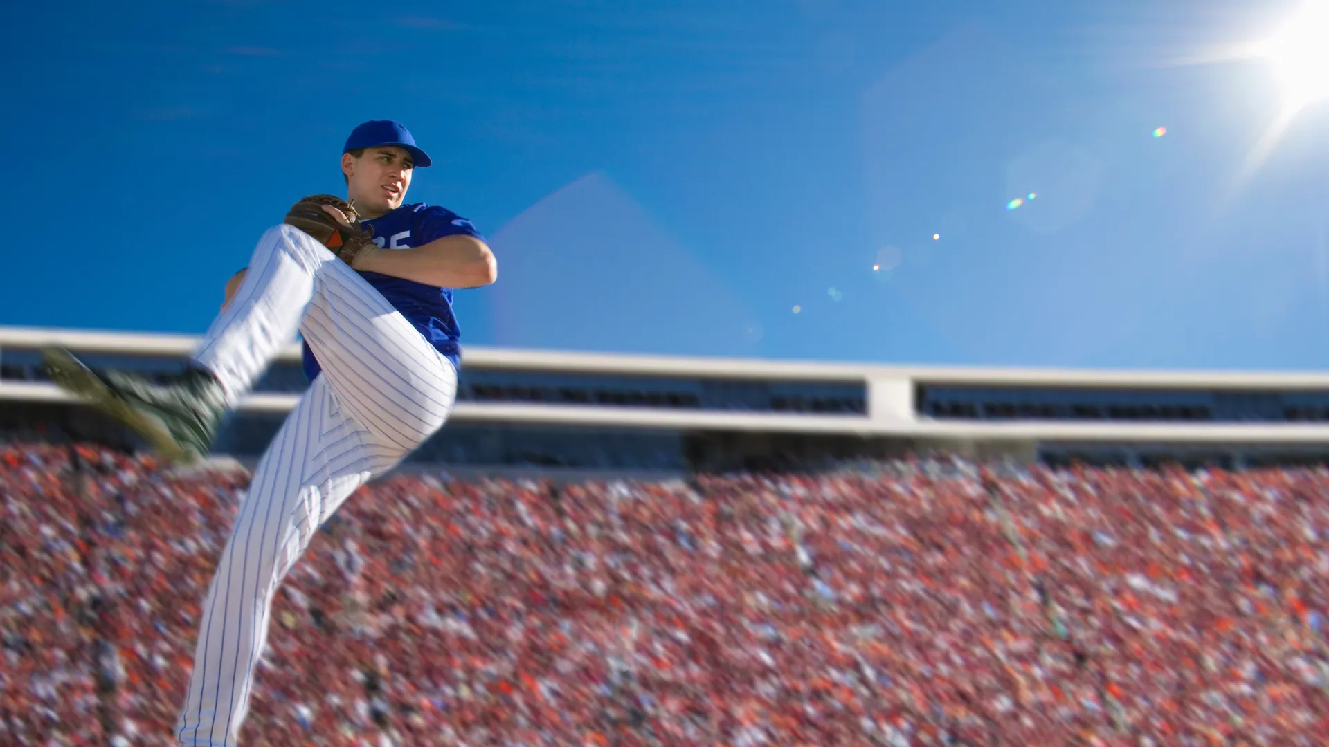 Baseball pitcher throwing in a crowded stadium for MLB Opening Day travel