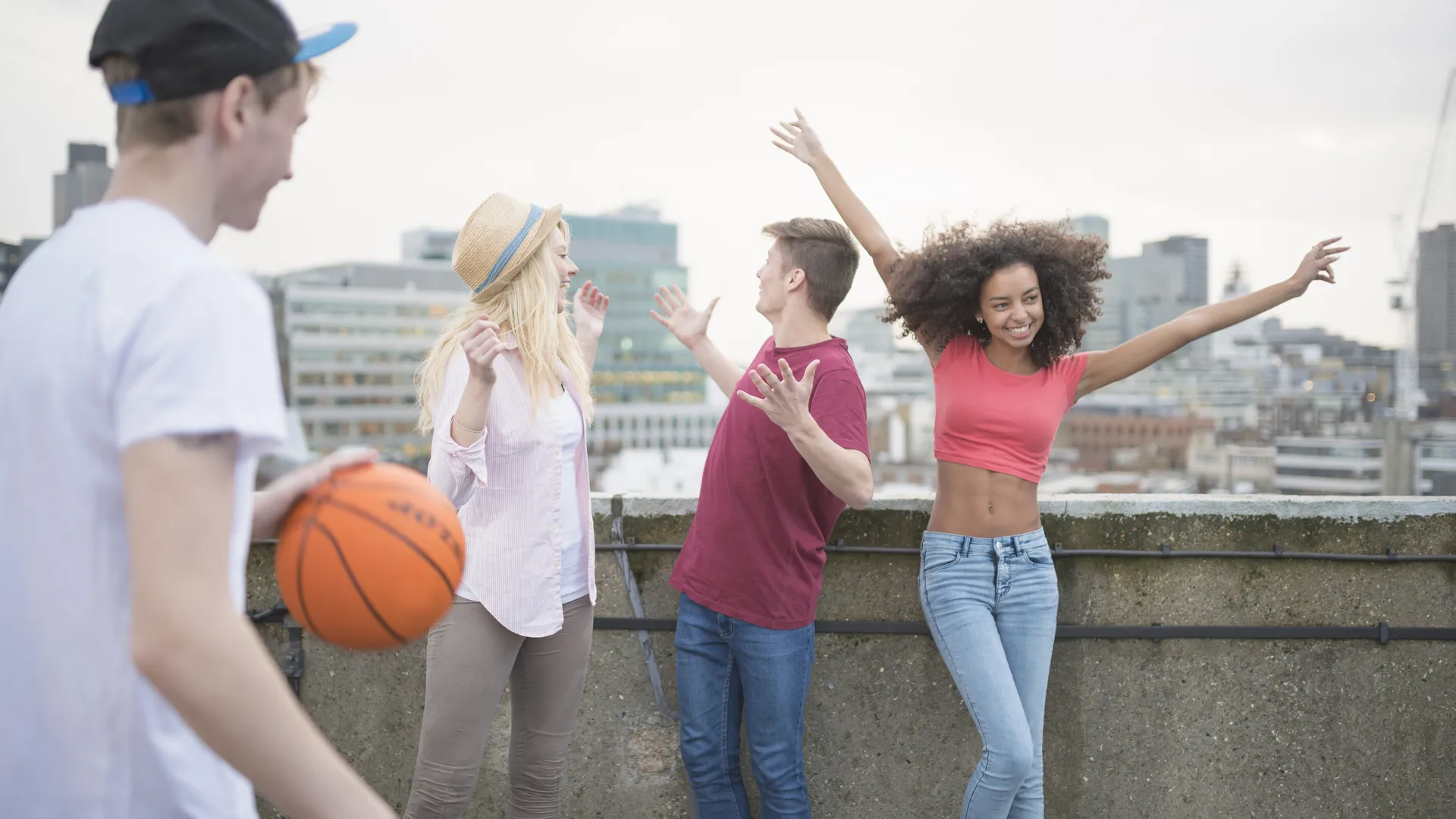 Friends with a basketball enjoying a city skyline view