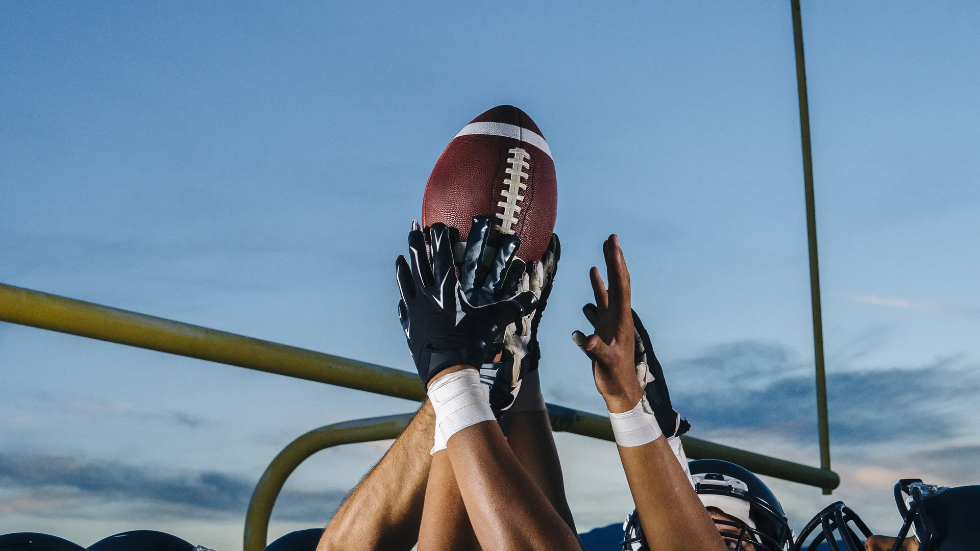 American football players celebrating outdoors for an NFL Wild Card Weekend playoff trip guide
