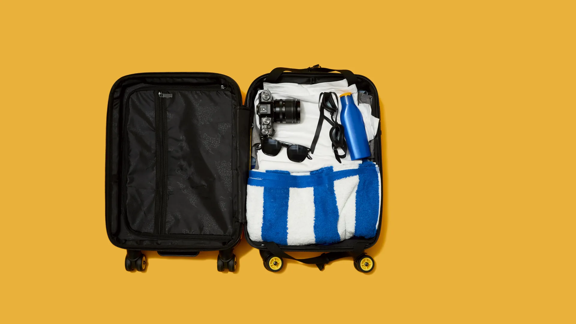 Open suitcase packed with travel gear for a sports weekend trip