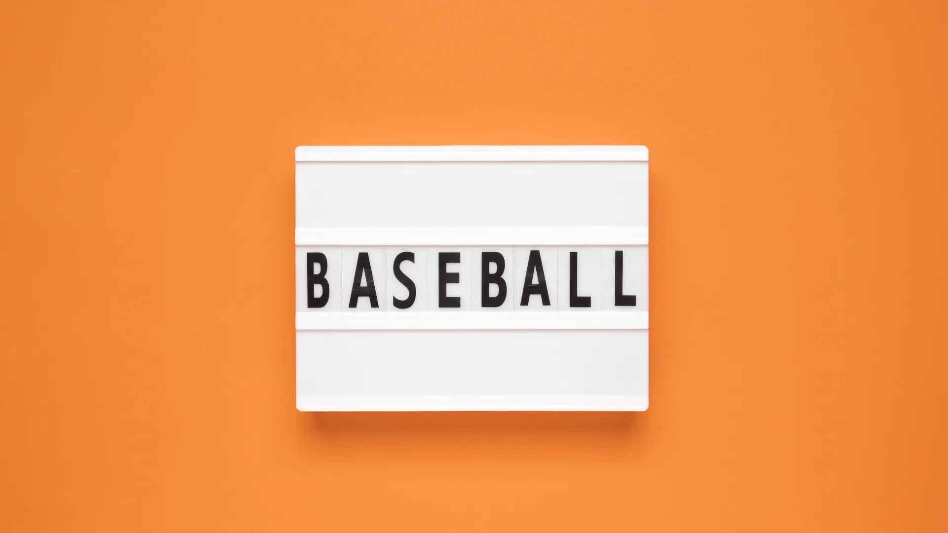 Baseball sign on an orange background for spring training planning
