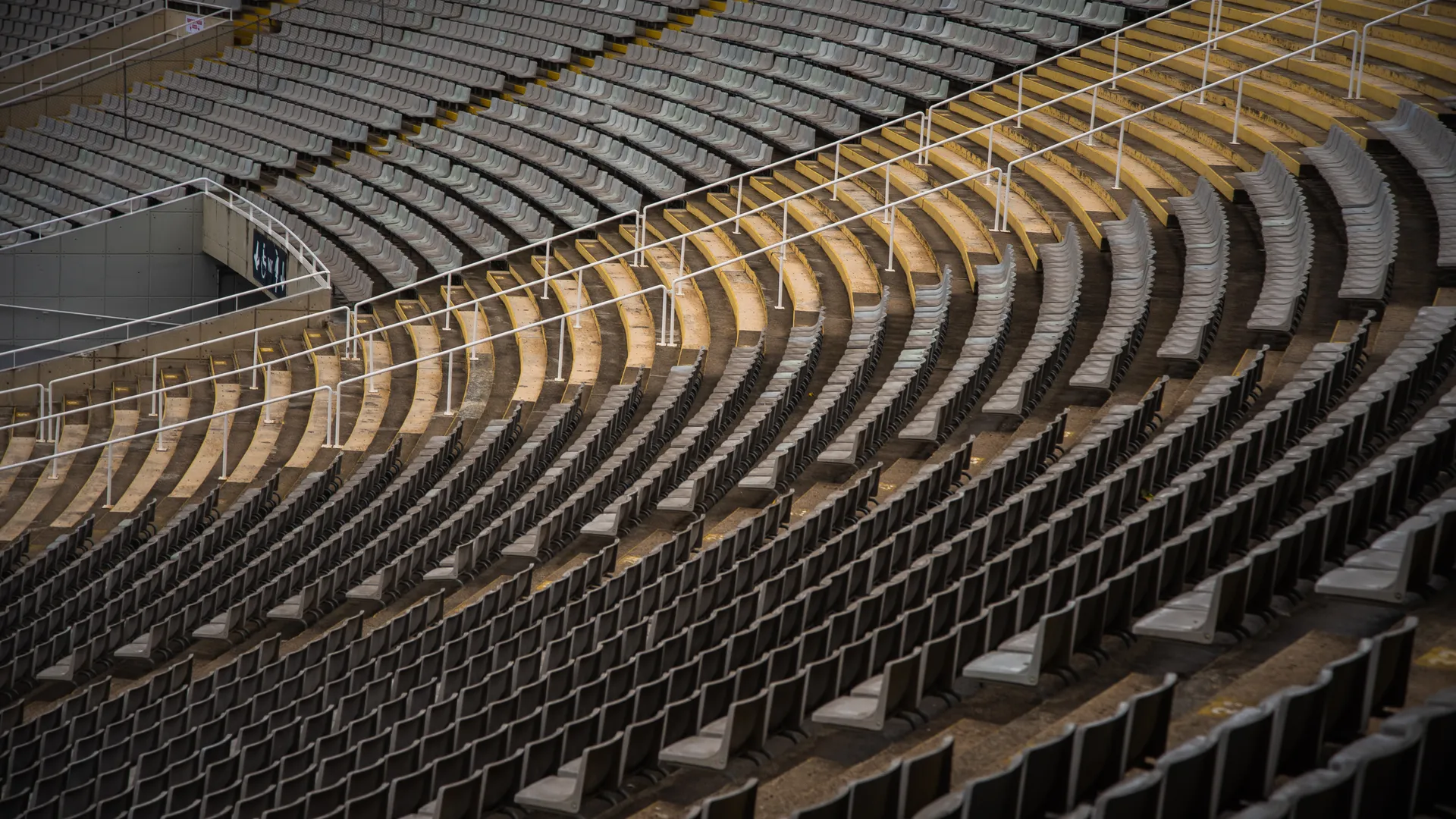 Rows of empty stadium seating in a large sports venue