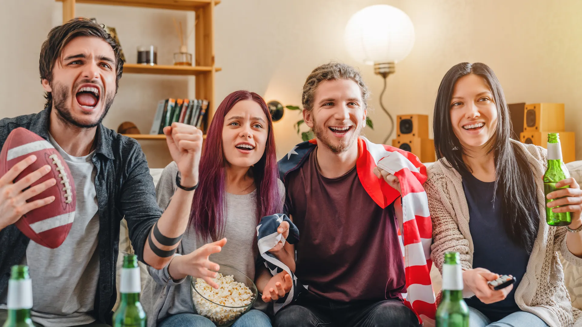 Football fans cheering while watching a game for a budget Super Bowl travel guide