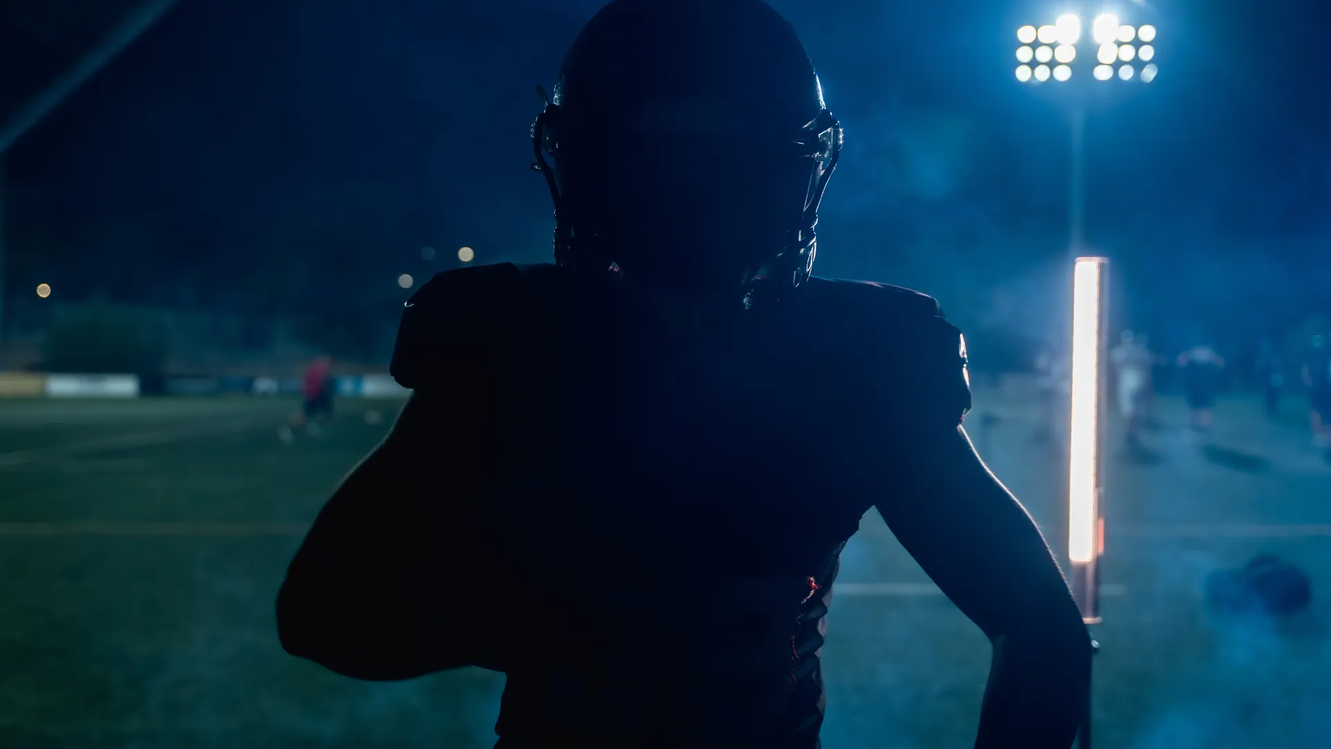 American football player under stadium lights at night for a championship travel guide
