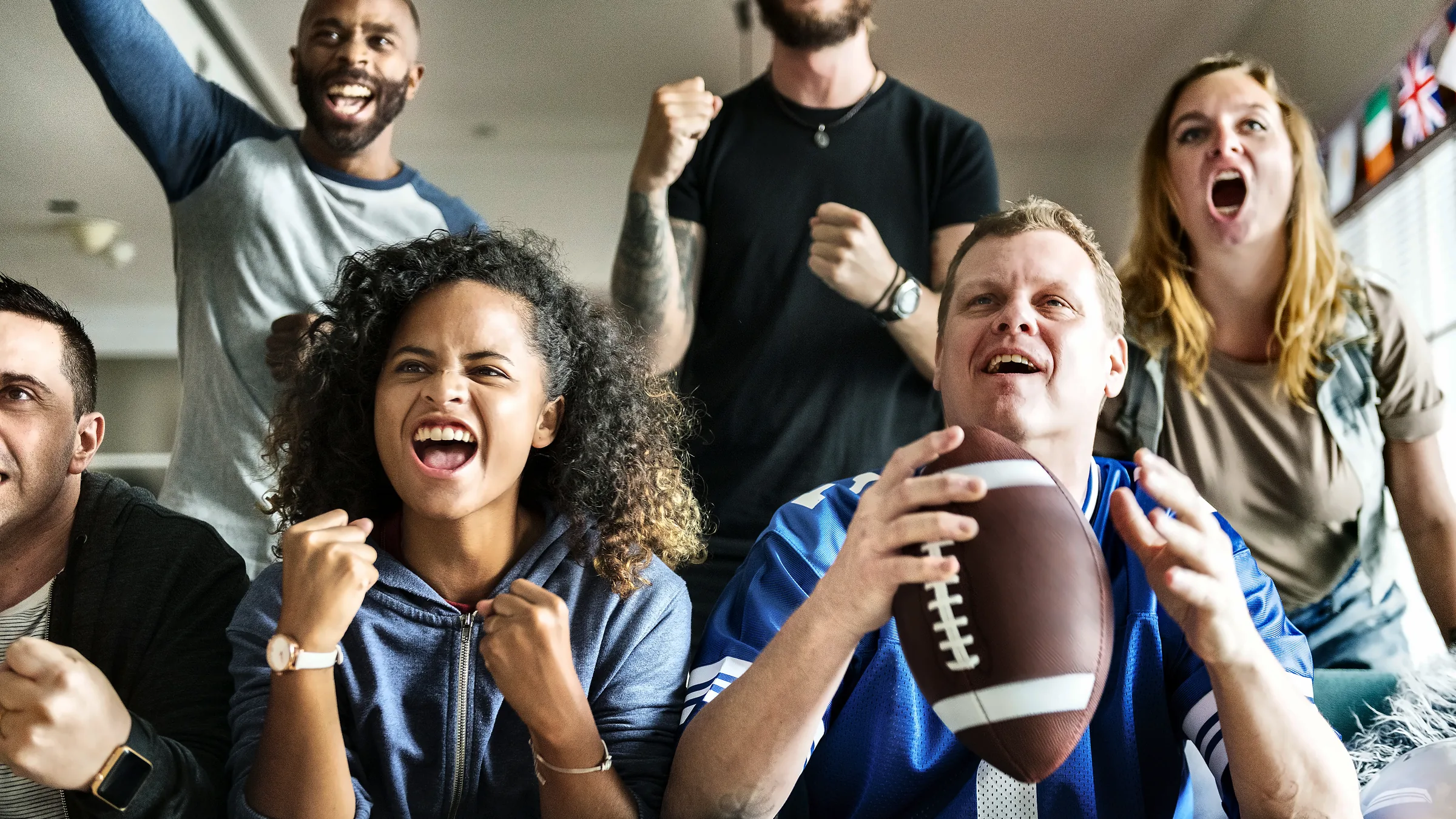 Football fans cheering together while watching a game