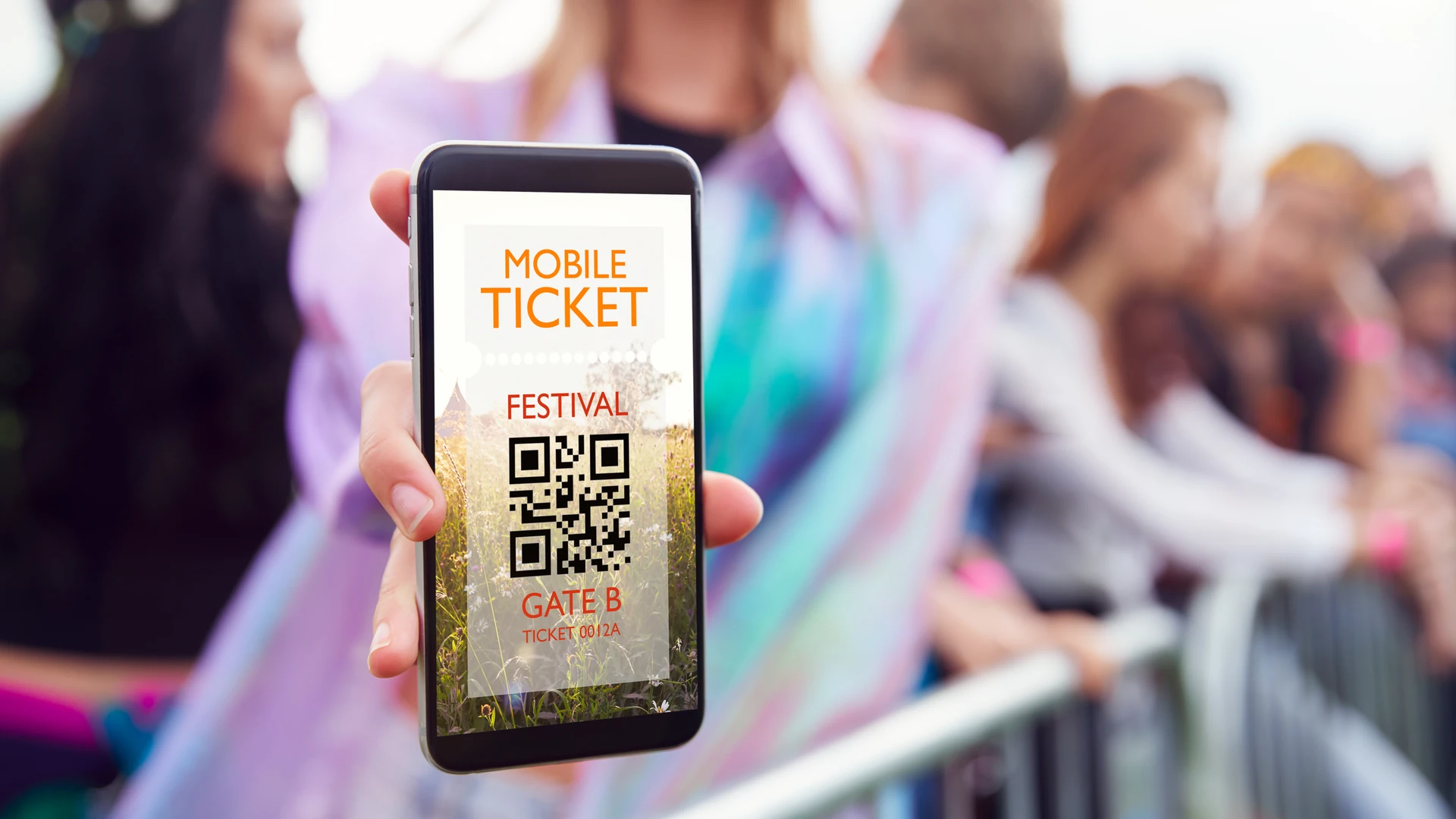 Smartphone displaying a festival mobile ticket with a QR code and Gate B label